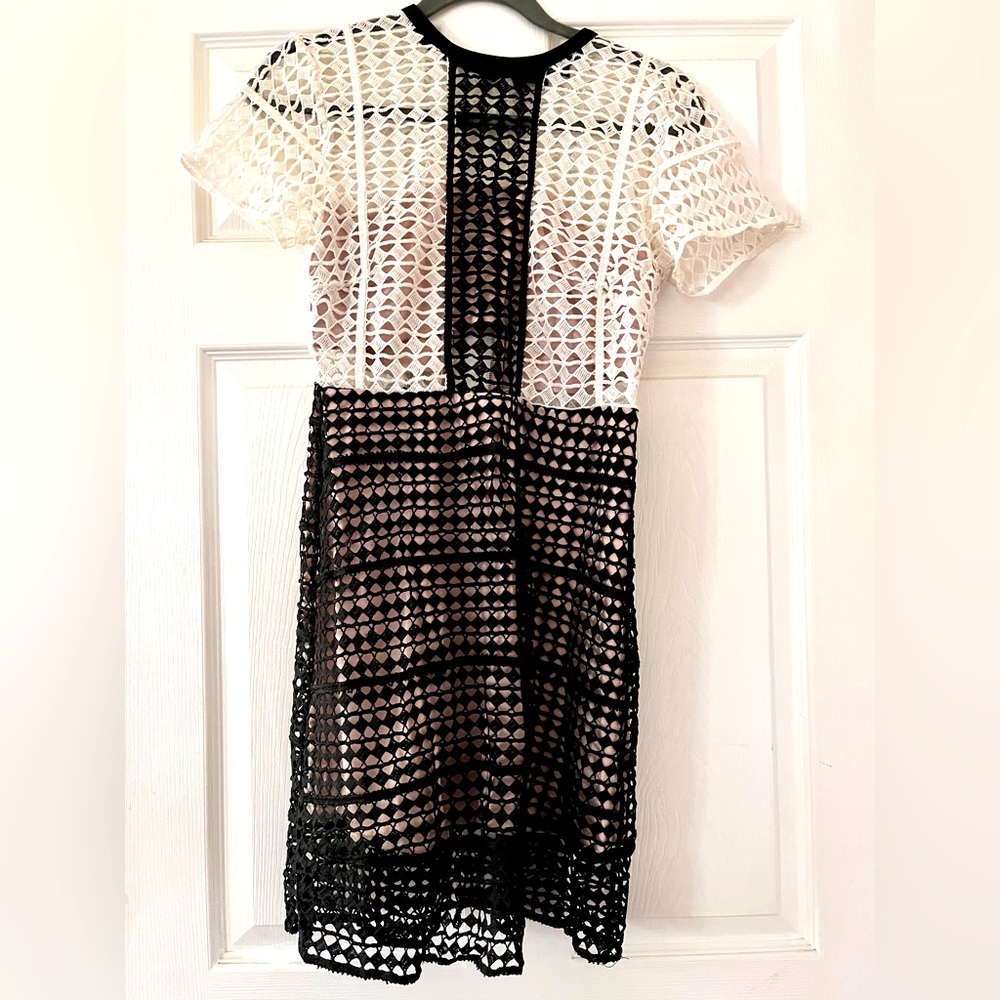 Never worn/ New cocktail dress with laser-cut holes throughout